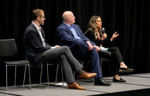 Construction procurement and supply chain experts speaking during a conference panel