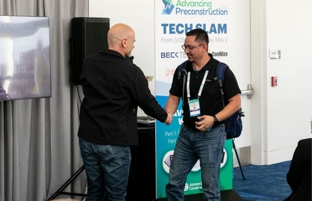 Construction professionals networking at an industry procurement conference